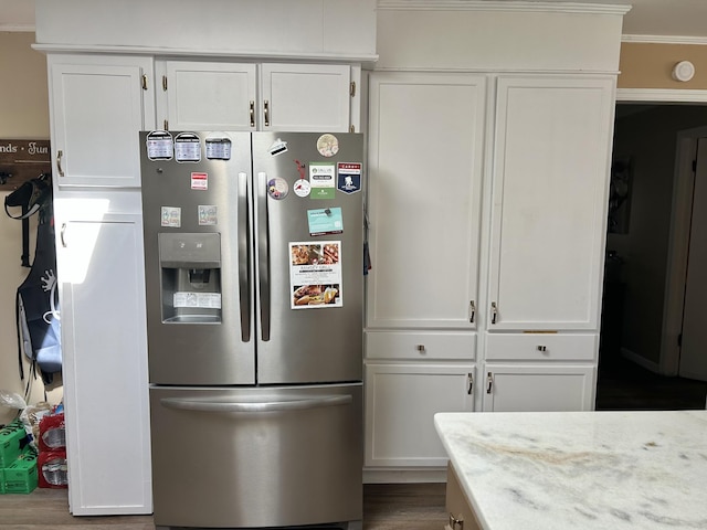 kitchen with dark wood finished floors, white cabinetry, light stone counters, and stainless steel fridge with ice dispenser