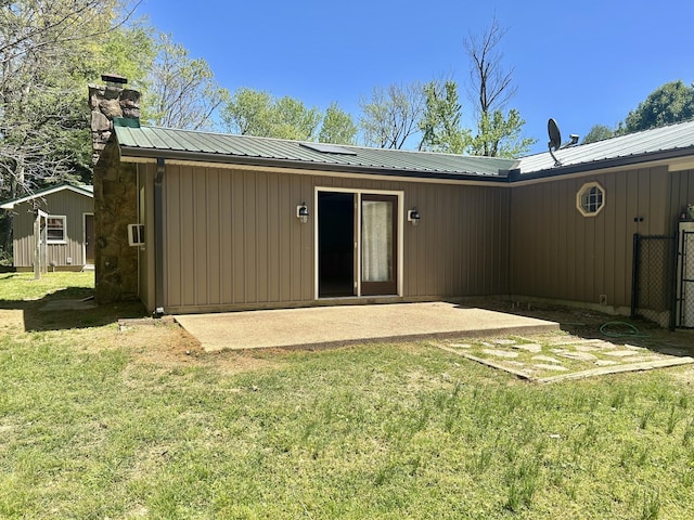 403 Bryan Blvd, Manchester, TN 37355 - back of house with a lawn, a chimney, a patio area, and metal roof