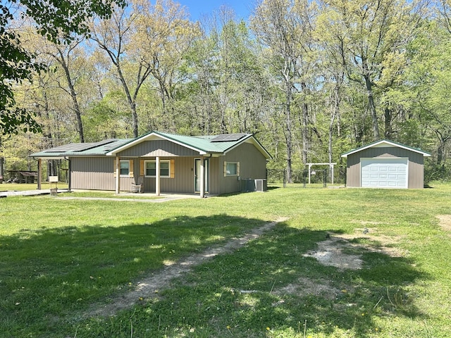 403 Bryan Blvd, Manchester, TN 37355 - back of house featuring a detached garage, an outbuilding, and central air condition unit