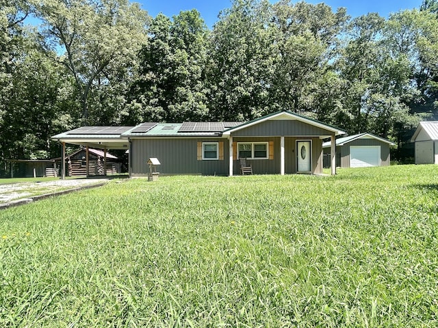 403 Bryan Blvd, Manchester, TN 37355 - view of front of property featuring roof mounted solar panels, an outbuilding, and a front lawn