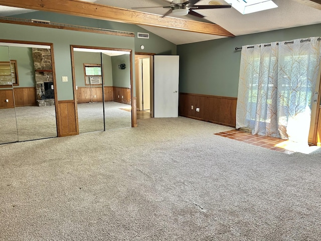 403 Bryan Blvd, Manchester, TN 37355 - unfurnished bedroom with a wainscoted wall, multiple windows, a skylight, carpet, and wood walls