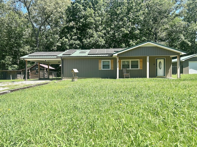403 Bryan Blvd, Manchester, TN 37355 - view of front of home featuring a carport, roof mounted solar panels, metal roof, a front lawn, and a porch