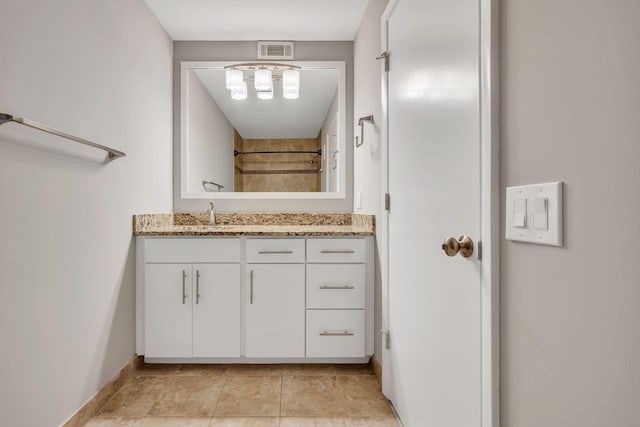 bathroom with tile patterned floors, vanity, visible vents, and baseboards