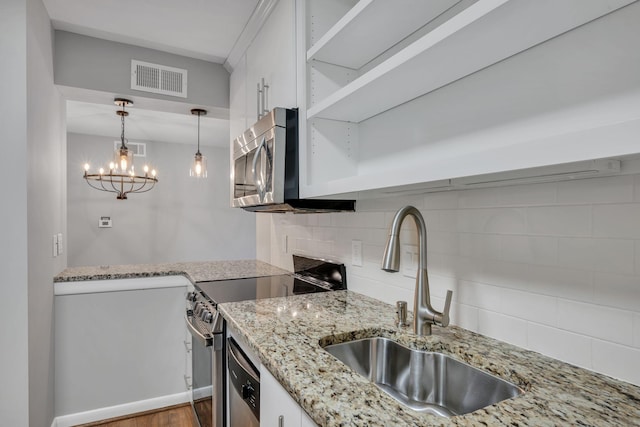 kitchen with a sink, visible vents, white cabinetry, appliances with stainless steel finishes, and open shelves