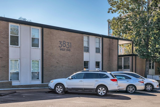 view of building exterior with uncovered parking