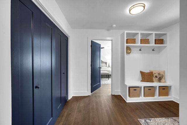 mudroom featuring dark wood-style floors and baseboards