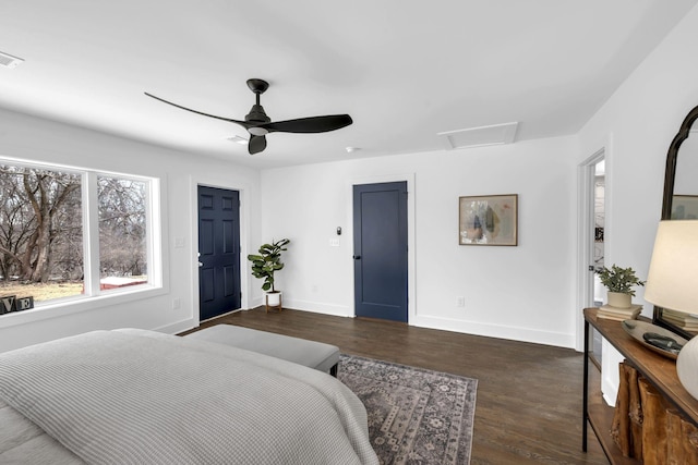 bedroom with dark wood-style flooring, visible vents, attic access, ceiling fan, and baseboards