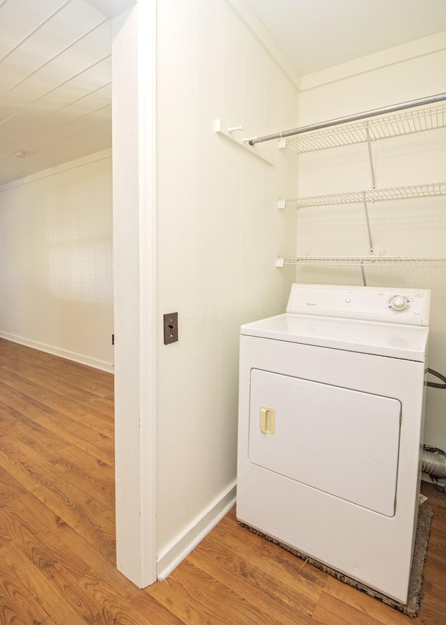 clothes washing area featuring washer / dryer, laundry area, and light wood finished floors