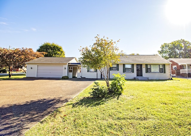 ranch-style home with a garage, driveway, and a front yard