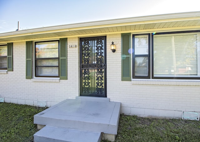 entrance to property with brick siding