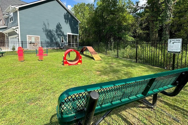 view of play area with fence and a lawn