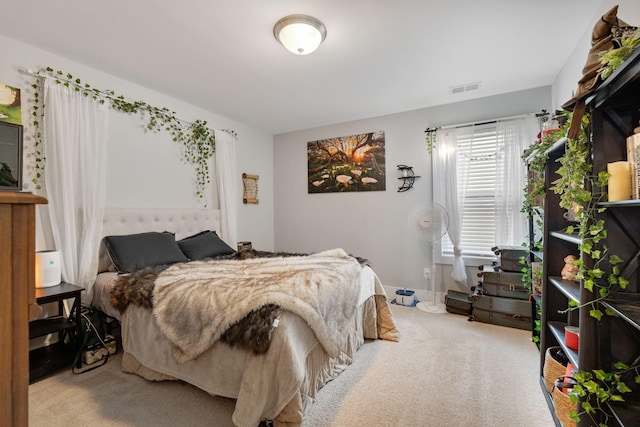 bedroom with light carpet and visible vents