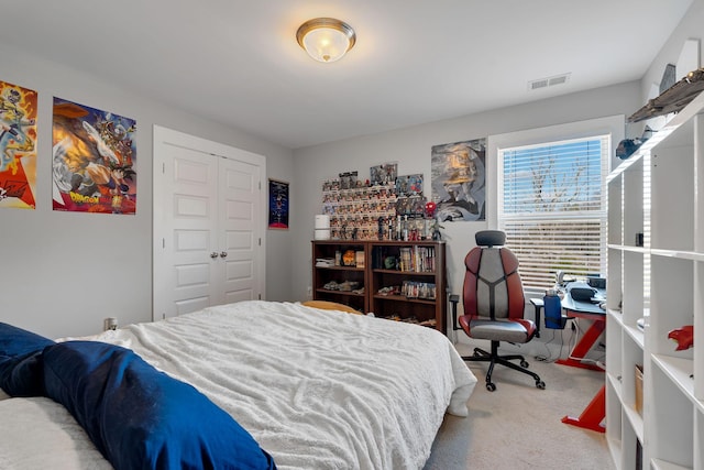 carpeted bedroom featuring a closet and visible vents