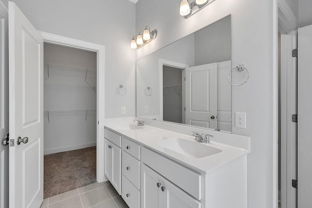 bathroom featuring double vanity, a sink, and tile patterned floors