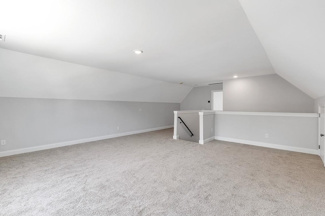 bonus room featuring recessed lighting, light carpet, vaulted ceiling, and baseboards