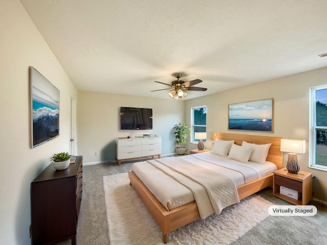 carpeted bedroom with ceiling fan, visible vents, and baseboards