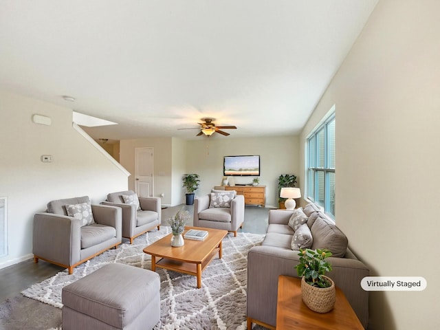 living area with ceiling fan, wood finished floors, visible vents, and baseboards