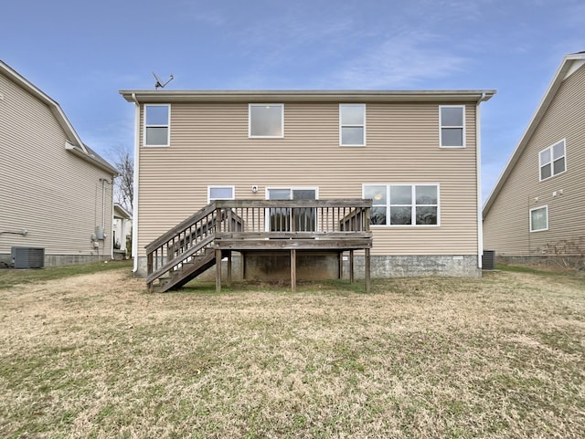 rear view of property featuring central AC unit, stairway, a wooden deck, and a lawn