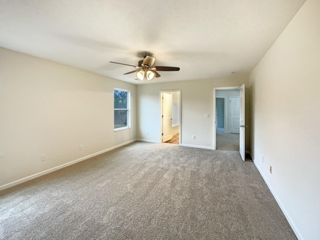 unfurnished bedroom with a ceiling fan, carpet, connected bathroom, and baseboards