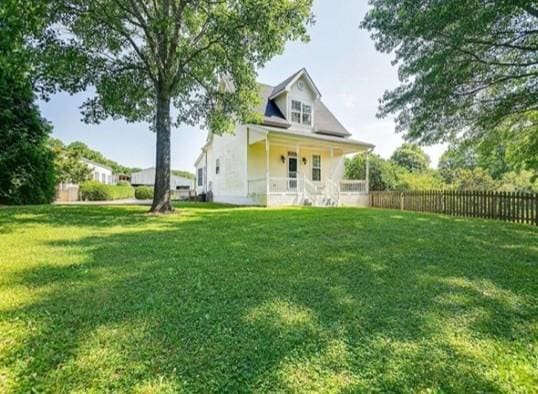 exterior space featuring a front yard and fence