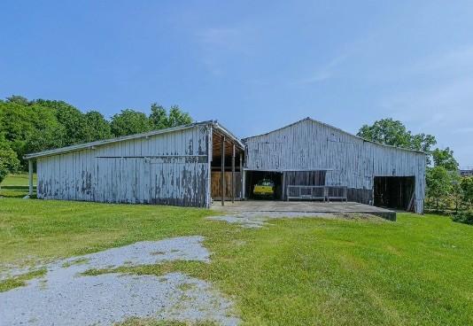 view of barn with a yard