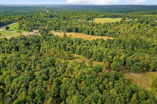 birds eye view of property featuring a view of trees