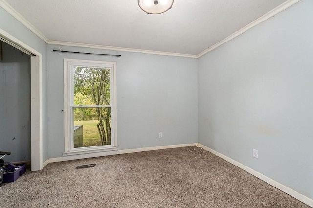 empty room featuring carpet flooring, visible vents, and baseboards