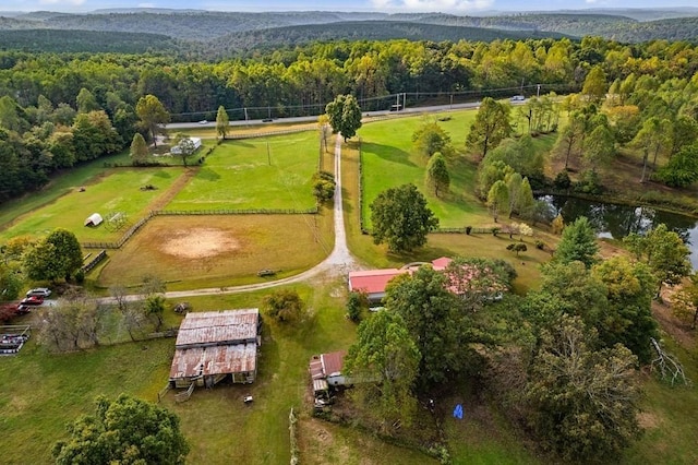 bird's eye view featuring a view of trees and a rural view