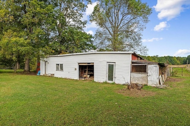 view of pole building featuring a yard and fence