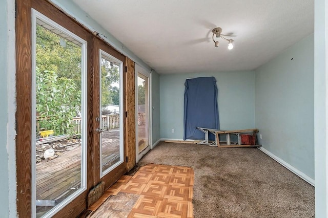 carpeted spare room with baseboards