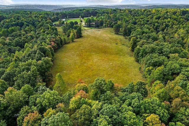 drone / aerial view featuring a wooded view