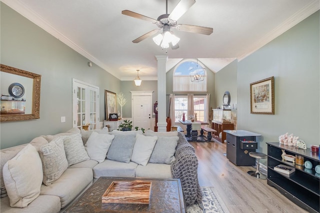 living room featuring decorative columns, wood finished floors, crown molding, french doors, and ceiling fan with notable chandelier