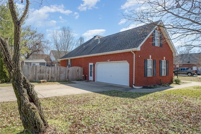 view of home's exterior with brick siding, a shingled roof, fence, a garage, and driveway