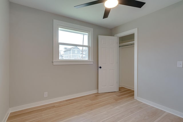 unfurnished bedroom with light wood finished floors, baseboards, and a ceiling fan