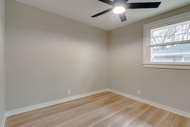 spare room with light wood finished floors, baseboards, and a ceiling fan