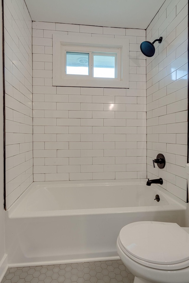 bathroom with toilet, tile patterned floors, and shower / bathing tub combination