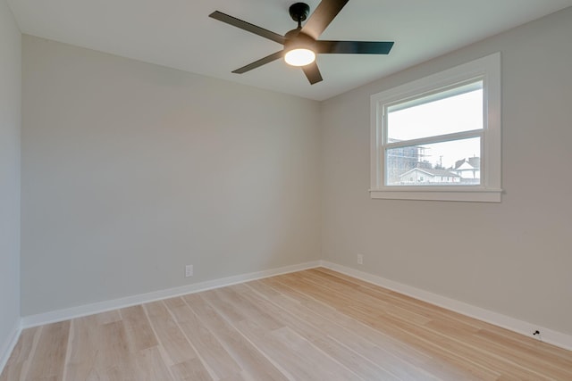 spare room with baseboards, a ceiling fan, and light wood-style floors