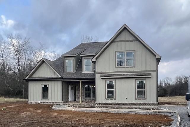 view of front of property with board and batten siding and roof with shingles