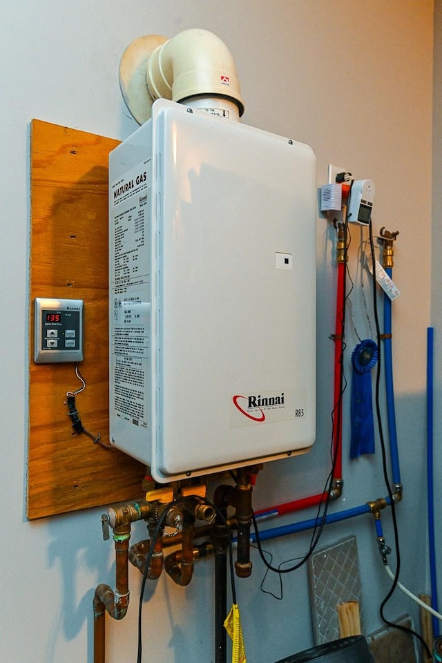 utility room featuring tankless water heater