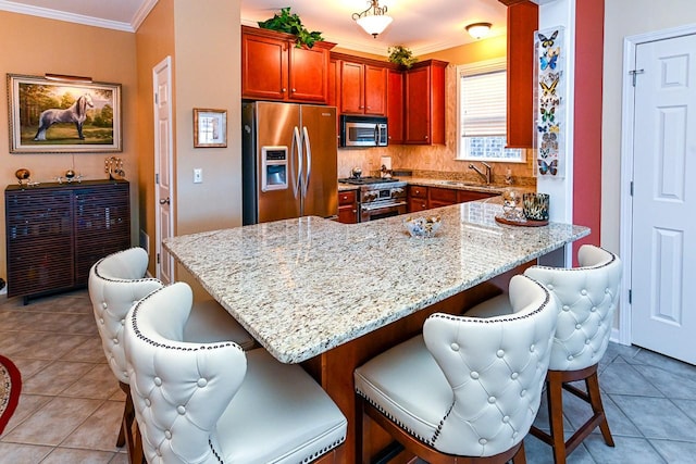 kitchen featuring appliances with stainless steel finishes, light tile patterned flooring, crown molding, and light stone countertops