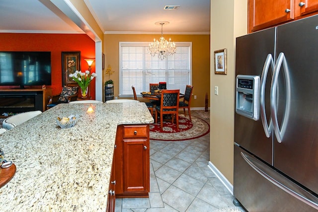 kitchen with stainless steel fridge, visible vents, a notable chandelier, and ornamental molding