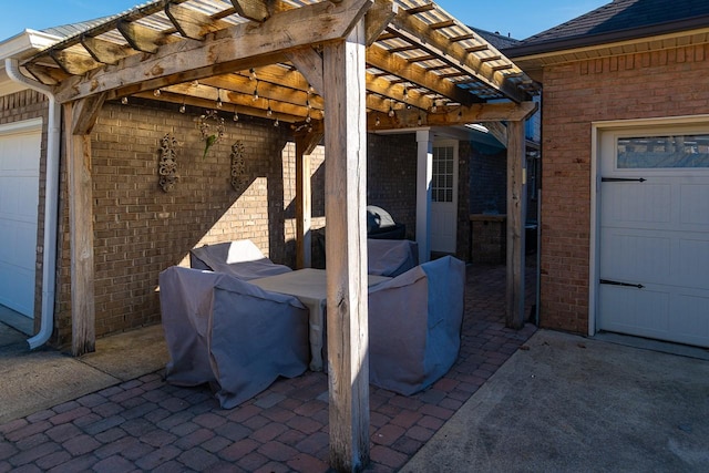 view of patio with a garage and a pergola