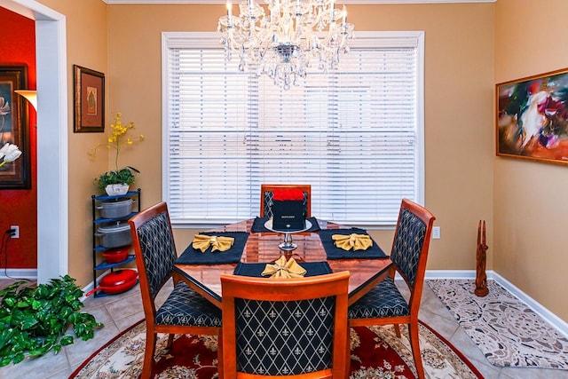 tiled dining room featuring a notable chandelier and baseboards