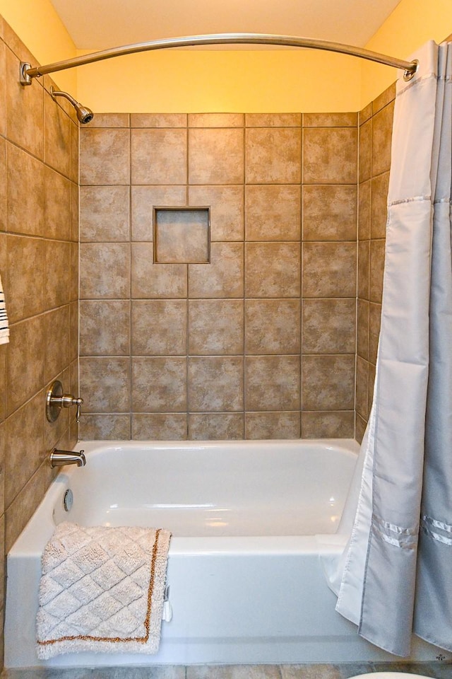 full bath featuring shower / tub combo with curtain