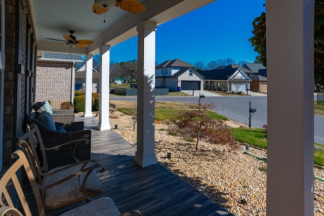 deck with covered porch, a residential view, and a ceiling fan