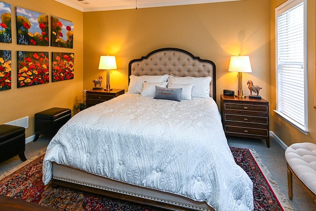 carpeted bedroom with visible vents, multiple windows, baseboards, and crown molding