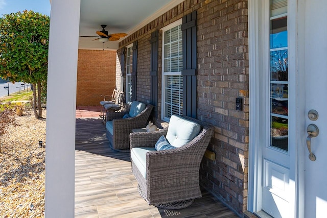 wooden deck with a porch and a ceiling fan