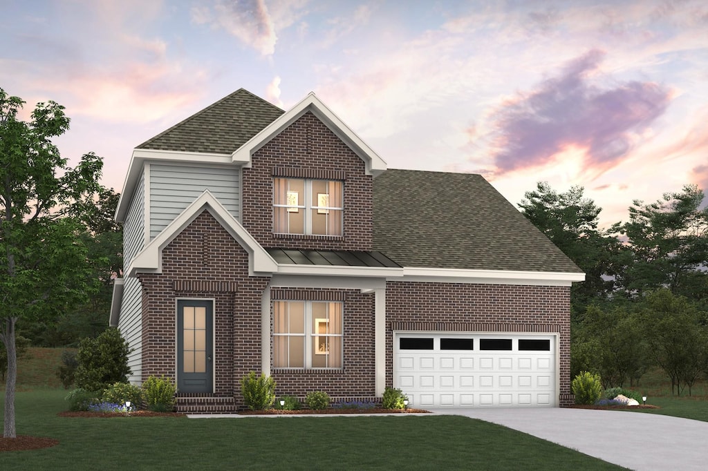 traditional home featuring a standing seam roof, roof with shingles, concrete driveway, and brick siding