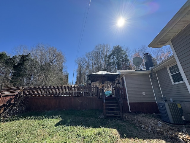 view of yard with central AC unit and a deck