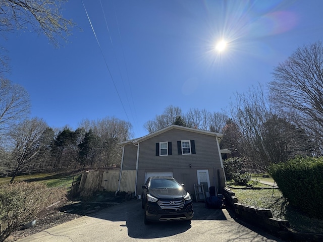 view of front of home featuring concrete driveway and a garage